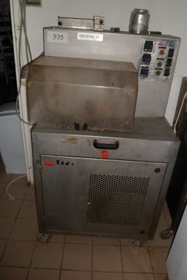 a metal oven sitting on top of a counter in a kitchen
