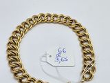 a gold chain bracelet with a tag on it