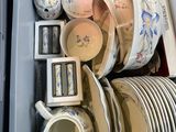 a lot of dishes and cups in a box