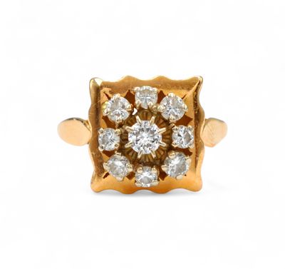 a close up of a gold ring with diamonds on it