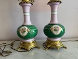 pair of green and pink vases with gold accents on a marble table