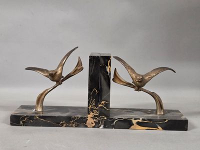 pair of black and gold marble bookends with birds on them