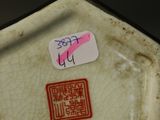 a small plate with a sticker on it sitting on a table