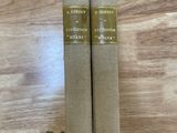 deux livres posés sur une table en bois, ornée d'un ruban vert