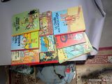 several children ' s books stacked on top of each other on a table