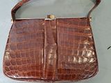 brown alligator skin purse with gold hardware and strap