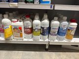 many bottles of cleaning products on a shelf in a store