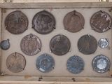 a wooden box with a bunch of coins inside of it
