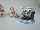 three figurines that are sitting next to each other on a table