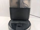 the coffee maker is sitting on top of a white table