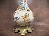 a white vase with a gold and blue design on it