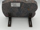 a rock with a label on it sitting on a stand