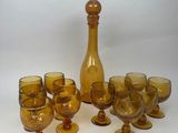 bottles and glasses are lined up on a white surface