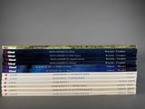 a stack of books sitting on top of a table next to each other