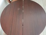 a table that has two chairs and a bag on it