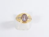 an image of a gold ring with a purple stone in the center