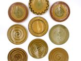 several plates are arranged in a circle on a white surface