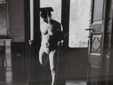 black and white photograph of a naked woman standing in a room