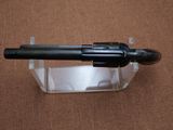 a gun that is sitting on top of a clear box
