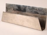 a silver metal business card holder on a white surface