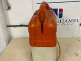 an orange and white blow dryer sitting on top of a wooden table