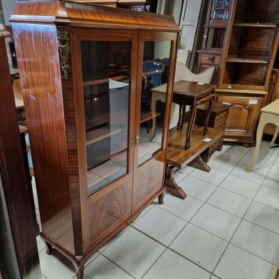 a display case with a clock on top of it in a room