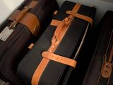several pieces of luggage are lined up against the wall