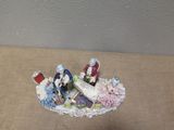 a miniature figurine of a couple on a plate