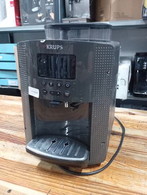 a coffee maker that is sitting on a wooden table