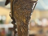 a bronze vase sitting on a table in a store