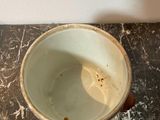a white cup sitting on top of a marble table