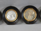 three oval black and gold picture frames with a picture of a man and a woman
