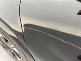 a close up of a car door with a dirty paint job on it