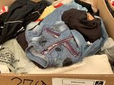 a cardboard box full of clothes in a store