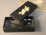 a small black box with a gold skull on it
