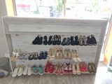 many pairs of shoes on display in a shoe store
