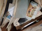 a pile of old books sitting on top of a cardboard box