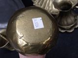 a person holding a gold vase with a sticker on it