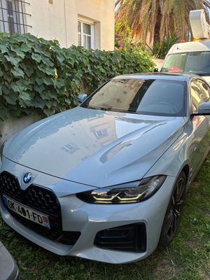 a silver car parked in front of a house