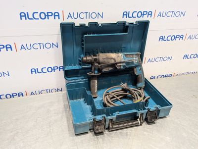 a blue tool box with a drill in it sitting on a floor