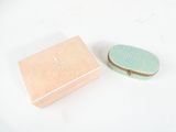 a small box with a lid sitting next to a smaller box