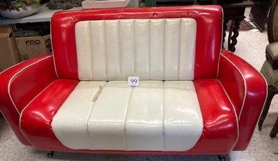 a red and white couch that is sitting in a room
