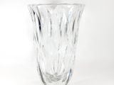 a glass vase that is sitting on a white surface