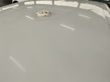 a white car with a smiley face on the hood of it