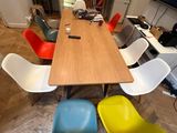 brightly colored chairs sit around a wooden table in a room