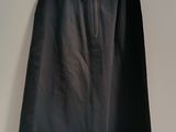 a black skirt hanging on a white wall next to a white wall