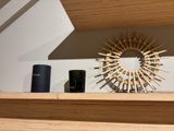 a clock on a shelf with a sunburst above it