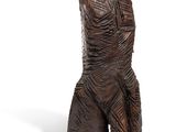 wooden statue of a man with a hat on his head on a white background