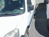 a white van parked next to a white van in a parking lot