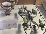two vases and a candle holder on a table